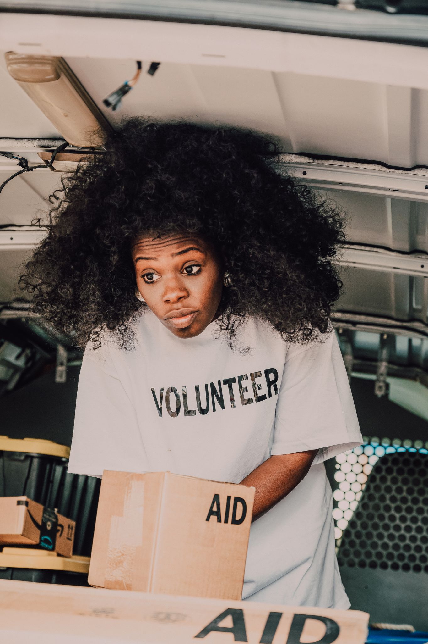 A dedicated volunteer sorting aid boxes, bringing hope and change.